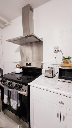 a kitchen with a stove and a stove top oven at New Renovated USA Side in Niagara Falls