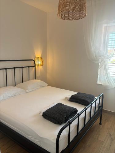 a bed with two pillows on it in a bedroom at Villa Regina Apartment Carlito with swimming pool in Jezera
