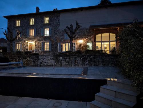 a house with a swimming pool in front of it at La Maison d'Arlette - Maison d'Hôte et Gite au coeur de l'Isère à 10 mn de Voiron, capitale de la Chartreuse, et du Lac de Paladru in Saint-Blaise-du-Buis