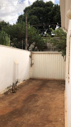 a white fence in front of a house at Kasa Kaya in Araraquara