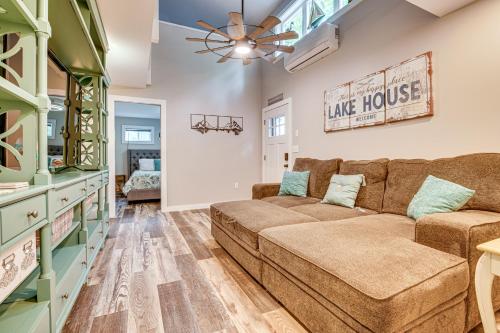 a living room with a couch and a table at Walk to Lake Beaches Cabin with Patio in Belmont! in Belmont