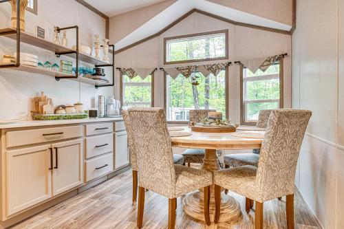 a kitchen with a wooden table and chairs at Walk to Lake Beaches Cabin with Patio in Belmont! in Belmont