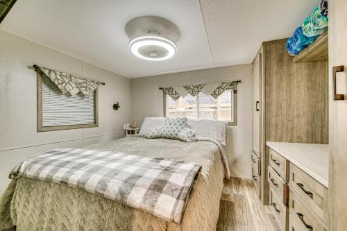 a bedroom with a bed and a sink at Walk to Lake Beaches Cabin with Patio in Belmont! in Belmont