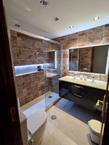 a bathroom with a shower and a toilet and a sink at Casa Zenn in Puerto del Rosario