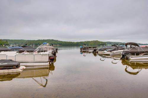 a group of boats are docked in the water at Walk to Lake Beaches Cabin with Patio in Belmont! in Belmont