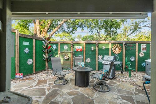 a patio with a table and chairs in a yard at 1929 Wash House in Fredericksburg