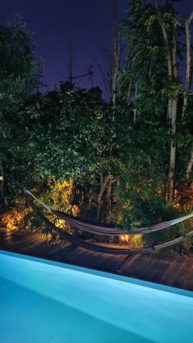 a view of a garden at night with lights at Charmante maison de ville en pierre avec piscine in Eysines