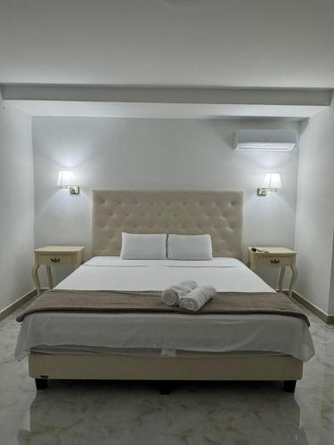a bedroom with a large bed with two night stands at Hotel The Royalty Inn in Guayaquil