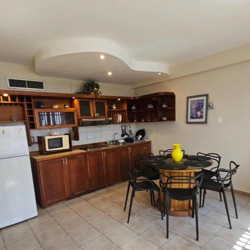 a kitchen with a table with chairs and a refrigerator at Oceanfront apartment in Morrocoy, Tucacas, PB in Tucacas