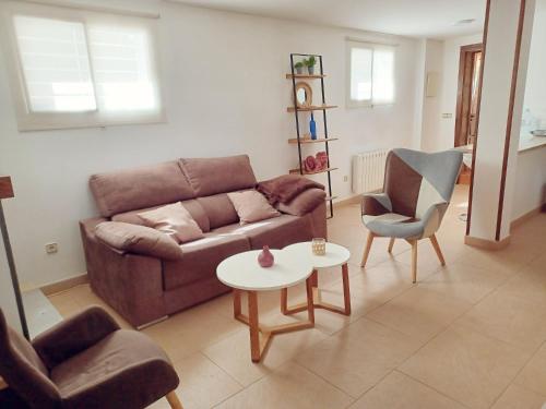 a living room with a couch and a table and chairs at Bonita casa en el bosque - El Tiemblo in El Tiemblo