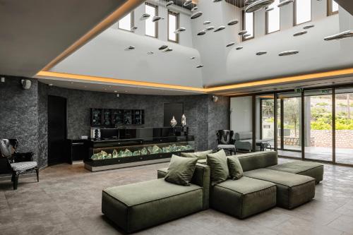 a living room with a couch and a table at Alas Resort & Spa in Elia Laconias