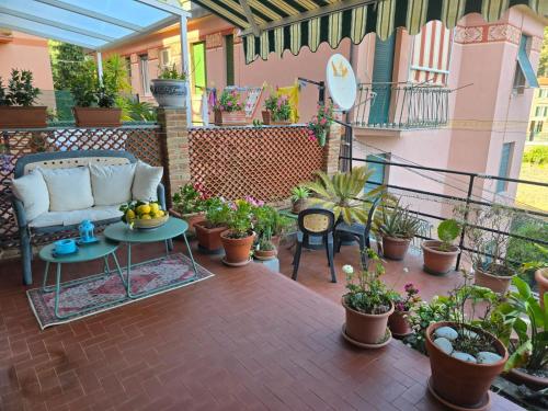 a patio with a couch and a table and potted plants at Casa Anna Maria in Monterosso al Mare