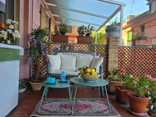a patio with a couch and a table with a bowl of fruit at Casa Anna Maria in Monterosso al Mare