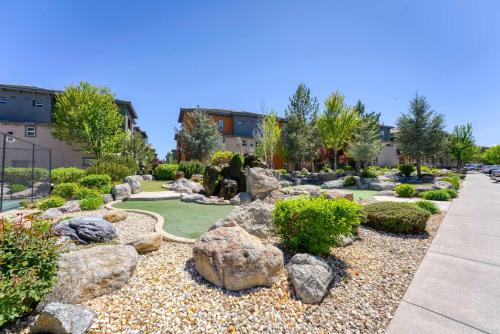 a garden with rocks and trees and a sidewalk at New Trendy 1BR Apartment with Heated Pool Gym & Minigolf in Reno