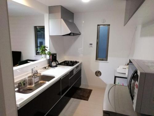 a kitchen with a sink and a stove at Kawasaki - House - Vacation STAY 9176 in Kawasaki