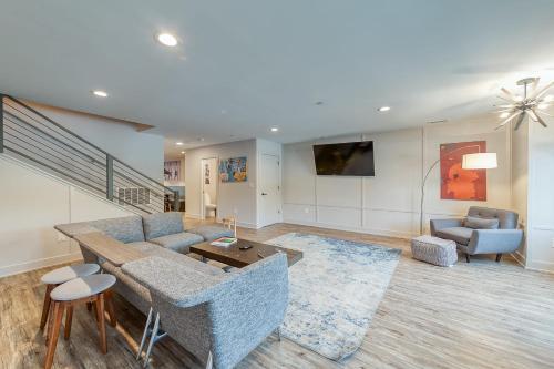 a living room with a couch and a table and chairs at Spacious & Spotless Home in A2 Walk to Big House in Ann Arbor