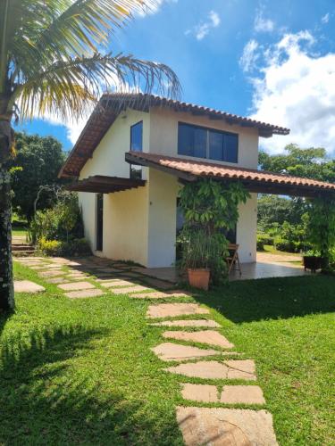 a house with a palm tree in front of it at Vista Bella HostHouse 1 in Brasilia