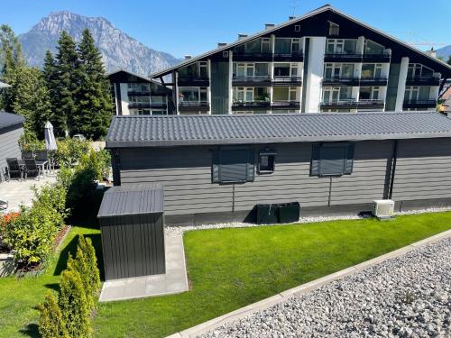 a house with a yard with a building in the background at Premium Chalet A in Ebenzweier