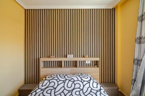 En eller flere senge i et værelse på Tropicana Holiday Home