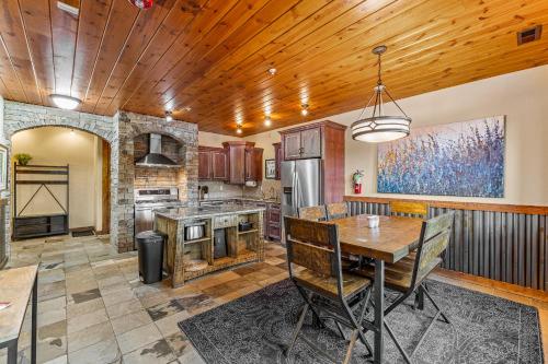 a kitchen with a wooden ceiling and a dining table at TimberCrest Downtown Lakeview Condo South by Casago McCall - Donerightmanagement in McCall