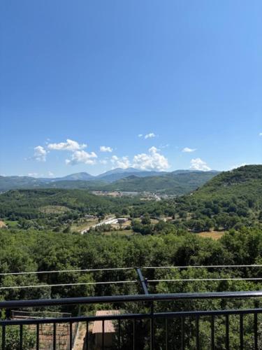 a view of a valley with trees and mountains at Yasmir Home in Grumento Nova
