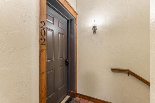 an open door with a light on a wall at TimberCrest Downtown Lakeview Condo South by Casago McCall - Donerightmanagement in McCall