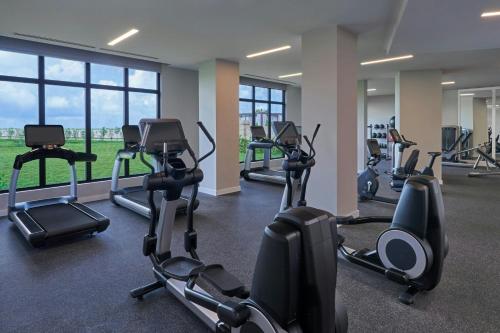 a gym with rows of treadmills and elliptical machines at The St. Regis Bermuda Resort in Saint George