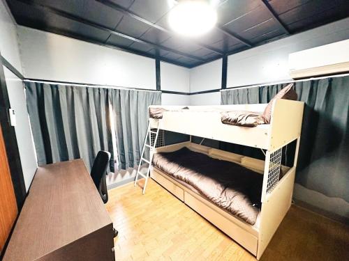 a room with a bunk bed and a table at Marutoku House Wakayama A - Vacation STAY 16947 in Wakayama