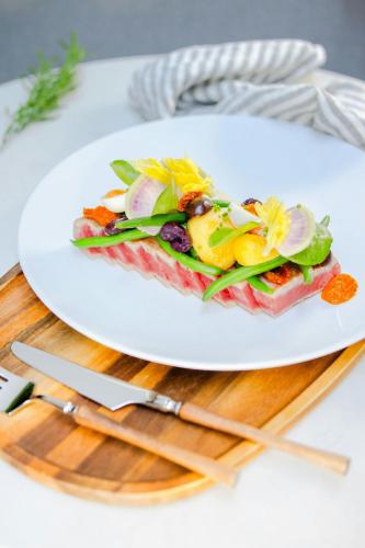 a white plate with a sandwich on a table at Sheraton Vancouver Guildford Hotel in Surrey