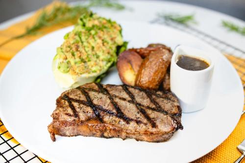 a plate of food with meat and bread on a table at Sheraton Vancouver Guildford Hotel in Surrey