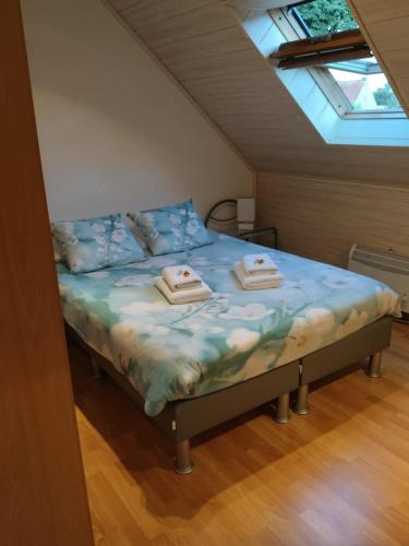 a bedroom with a bed with two towels on it at Duinzicht in Koksijde