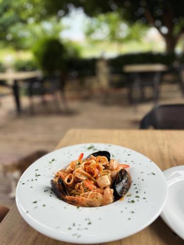 a white plate of food on a table at Vila Benvenuto Belsh in Belsh