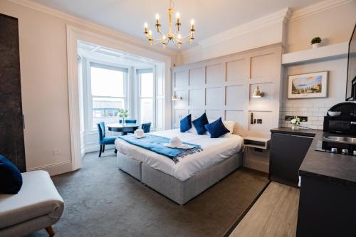 a bedroom with a bed and a table and a kitchen at Studio with Scenic Marina Views in Dublin