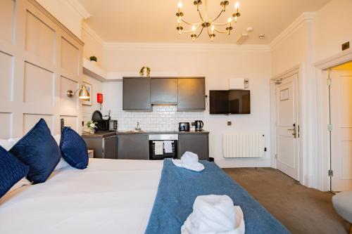 a large bedroom with a large white bed with blue pillows at Studio with Scenic Marina Views in Dublin
