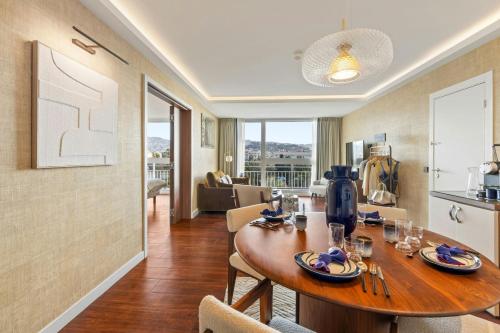 a dining room with a table and a kitchen at Le Meridien Nice in Nice