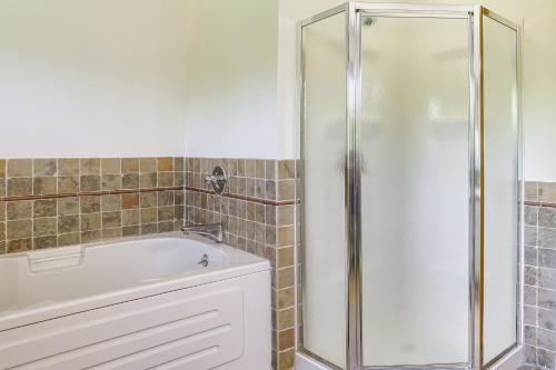 a bathroom with a bath tub and a shower at Play, Swim and Unwind Family Home in Glen Wild! in Glen Wild