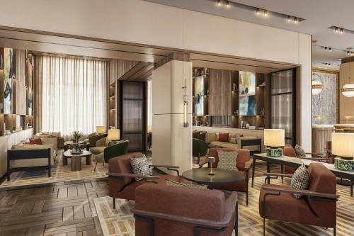 a lobby with couches and chairs and tables at Berlin Marriott Hotel in Berlin