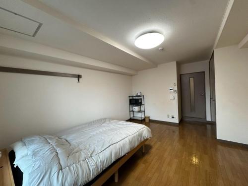 a bedroom with a bed in a room at Hare no hi Hakushima - Vacation STAY 94996v in Hiroshima