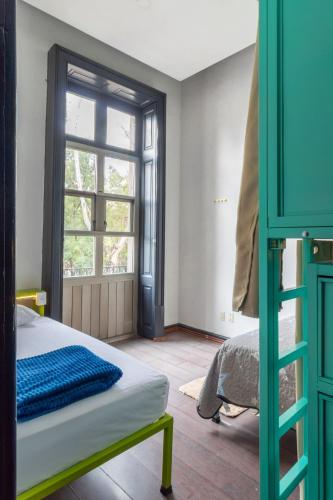 a bedroom with a bunk bed and a window at Hostel Bemaro Mexico City in Mexico City