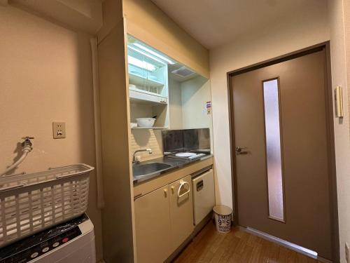 a small kitchen with a sink and a counter at Hare no hi Hakushima - Vacation STAY 94996v in Hiroshima