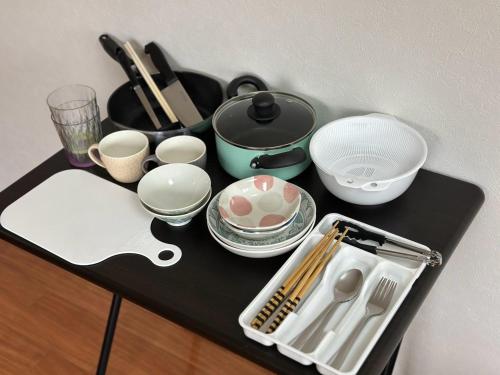a black counter with dishes and utensils on it at Hare no hi Hakushima - Vacation STAY 94996v in Hiroshima