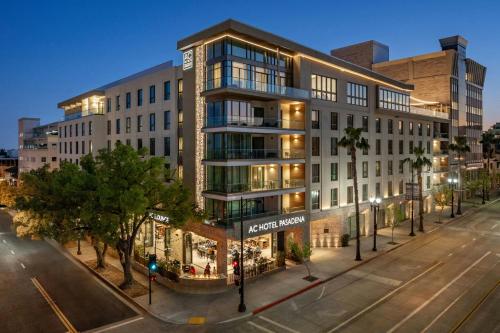 an apartment building on a city street at night at AC Hotel Pasadena in Pasadena