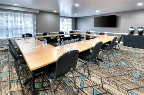 a conference room with a large wooden table and chairs at Residence Inn by Marriott Whitby in Whitby