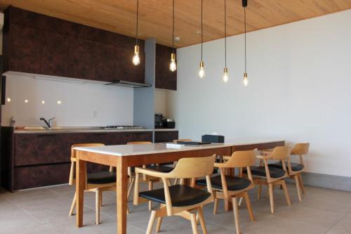 a kitchen with a wooden table and chairs at Villa Mikuri Tsunoshima - Vacation STAY 02176v in Shimonoseki