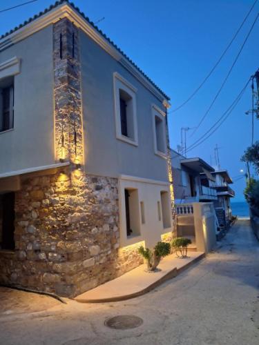 a stone building with lights on the side of it at Lotza apartments in Vrontados