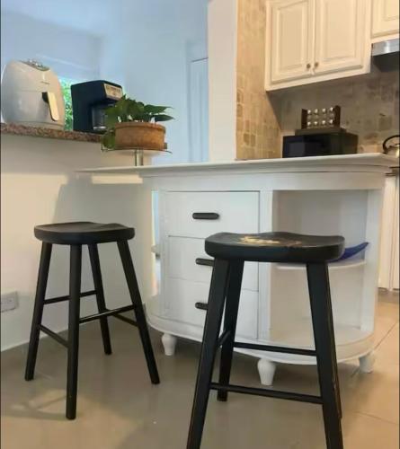 two black stools in front of a kitchen counter at Villa Puntacana Village near by the airport and beach in Punta Cana