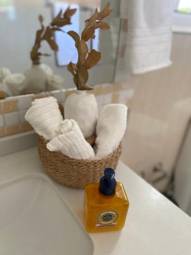 a basket of towels on a counter with a soap dispenser at Villa Puntacana Village near by the airport and beach in Punta Cana