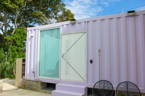 a pink shipping container with a large door at Villa Mikuri Tsunoshima - Vacation STAY 02209v in Shimonoseki