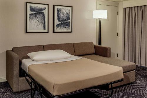 a couch and a bed in a room at Renaissance Boston Seaport District in Boston