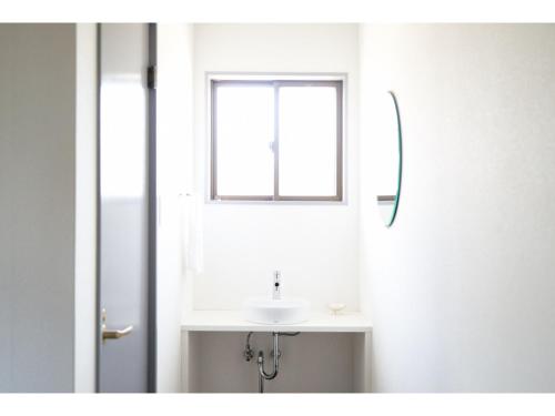 a bathroom with a sink and a window at Tengu Tabine-Cotengu Tabine - Vacation STAY 04453v in Kanazawa